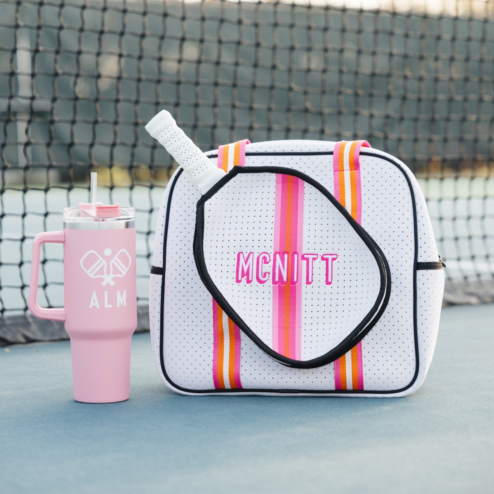 A navy and white pickleball bag is customized with a blue monogram.