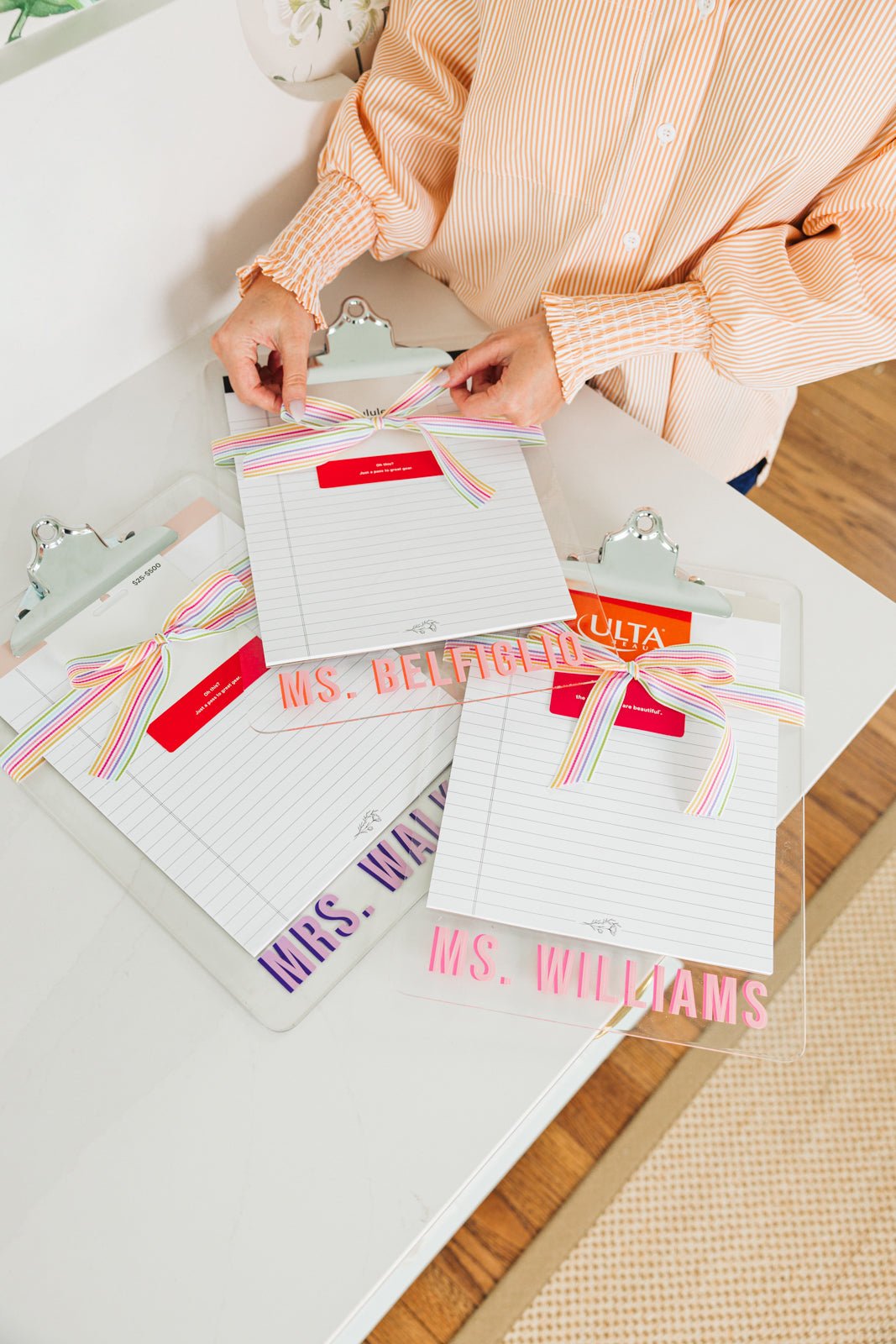 Set of two personalized acrylic clipboards, each featuring a unique monogram or name. One clipboard showcases 'AMD' in bold blue lettering, while the other displays 'MS JONES' in striking red and blue. The clear acrylic design adds a sleek, modern touch, making these custom clipboards perfect for teachers, professionals, or office organization.