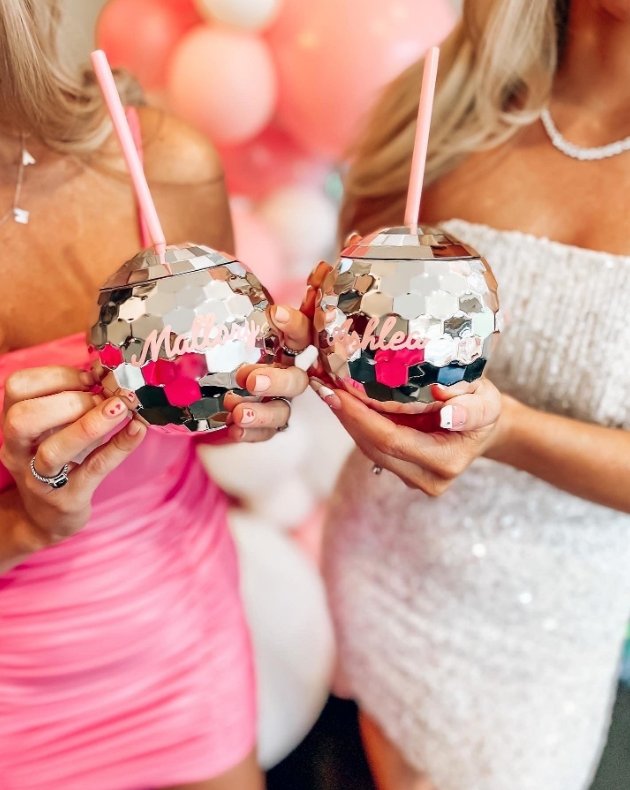 A silver disco ball tumbler that reads "Sophia" in pink script